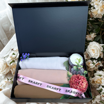 3 different colour Hijabs in a black box with scented candle and flowers