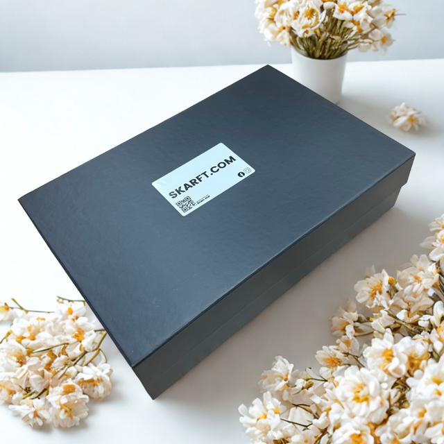 scarf gift box in black on a table with flowers